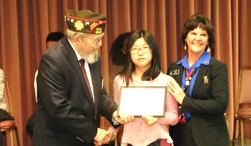State Commander and President awarding citation to young lady for her efforts.